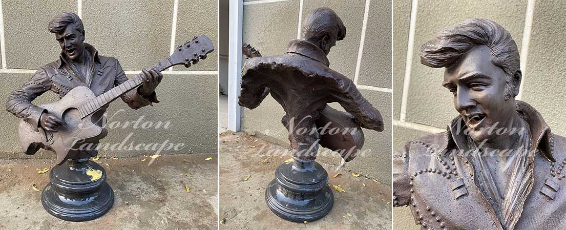 bronze man playing guitar statue