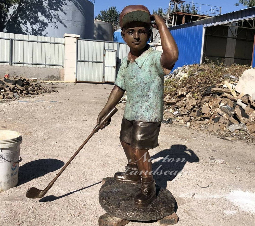 Bronze statue of little boy playing golf