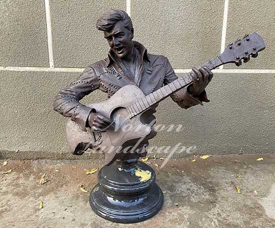 bronze man playing guitar statue