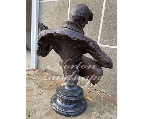 bronze man playing guitar statue