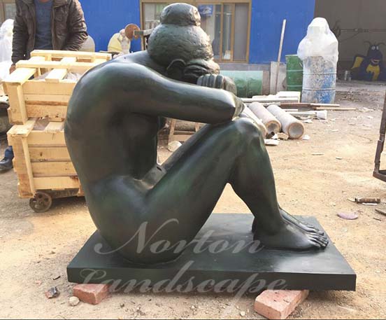 Bronze sitting nude woman statue