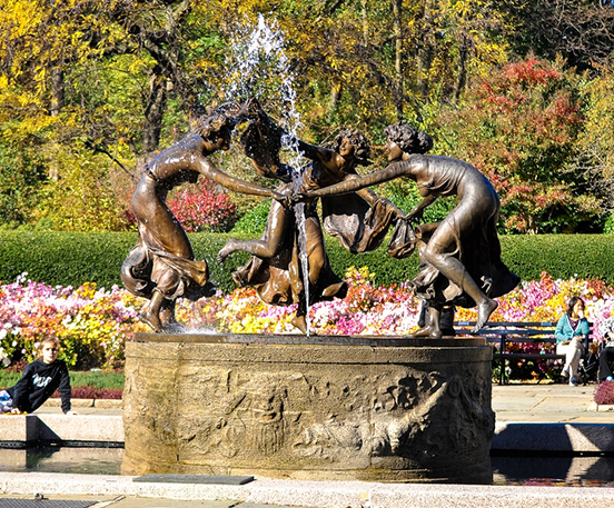 Bronze women playing statue fountain