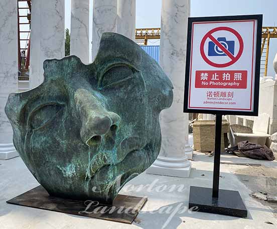 Bronze face statue