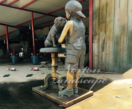 Bronze boy and dog statues