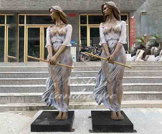 Bronze lady holding a flute statue