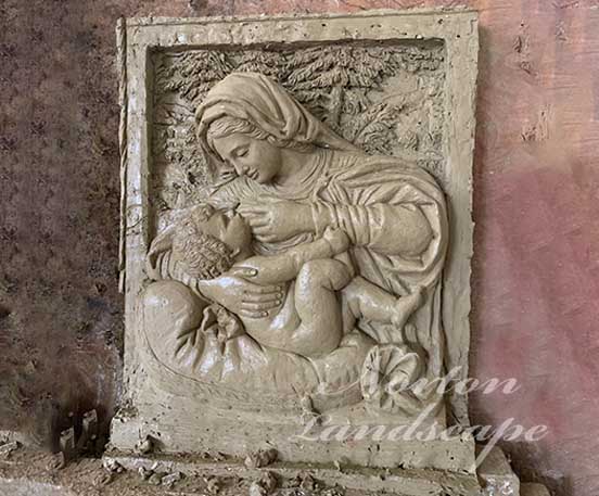 Bronze mother and son relief